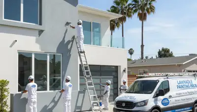 Professional house painters working on residential exterior in Los Angeles, CA