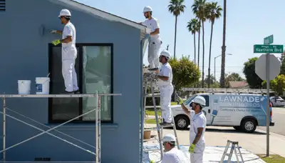 Professional house painters working on exterior home in Los Angeles, CA