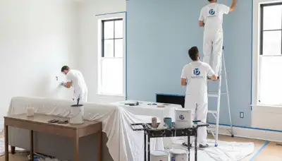 Professional interior house painters finishing living room walls in Los Angeles, CA